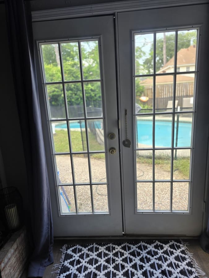 French patio doors with fresh hardware overlooking a pool