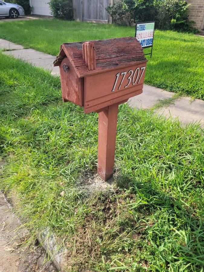 Reset wooden mailbox post at the curb
