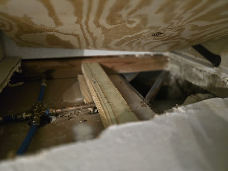 Copper and PEX water lines repaired beneath a subfloor