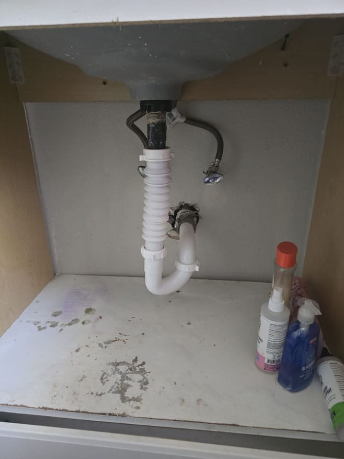 New drain lines and trap installed under a sink