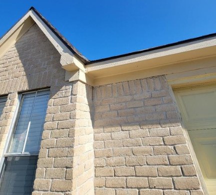 Repainted gable trim and brick on a Houston home