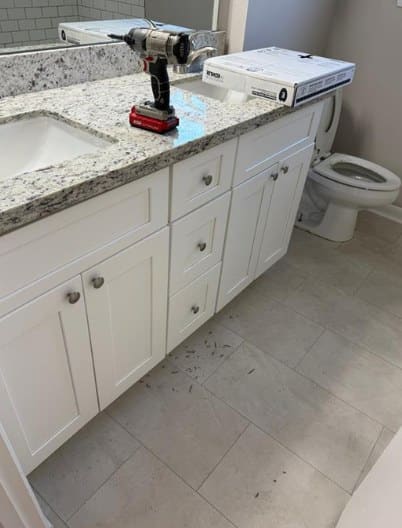 New white vanity with granite top during installation